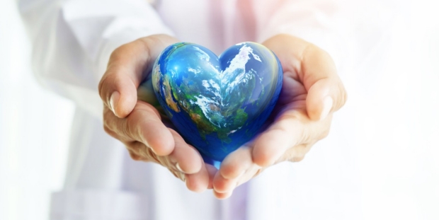 Hands hold Earth ball in heart shape on Doctor hands  for World Health Day content and copy space.Elements of this image furnished by NASA